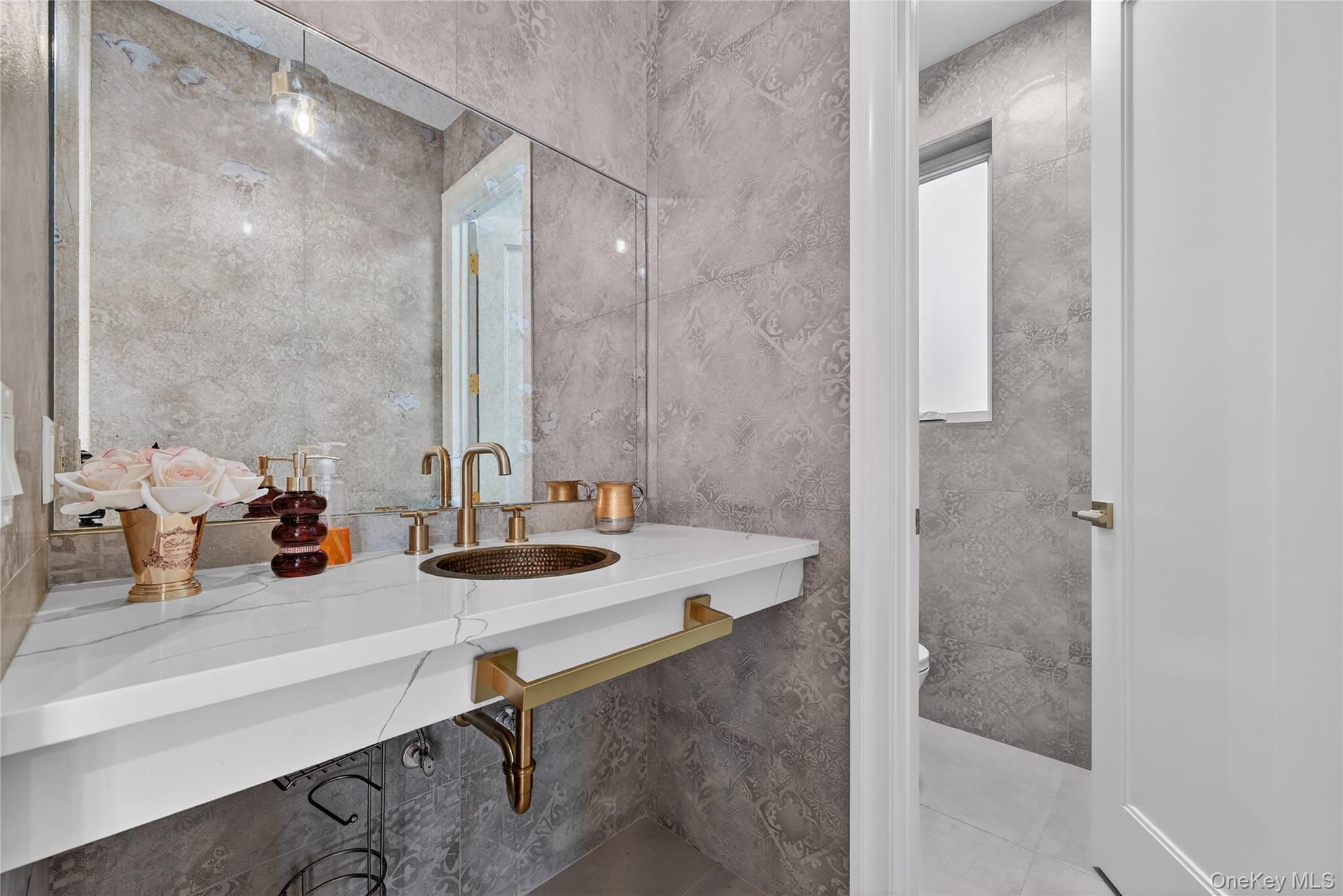 27 Ellish Parkway, Unit 202 Spring Valley, NY 10977 - Photo 21 of 50 a bathroom with a sink and a mirror