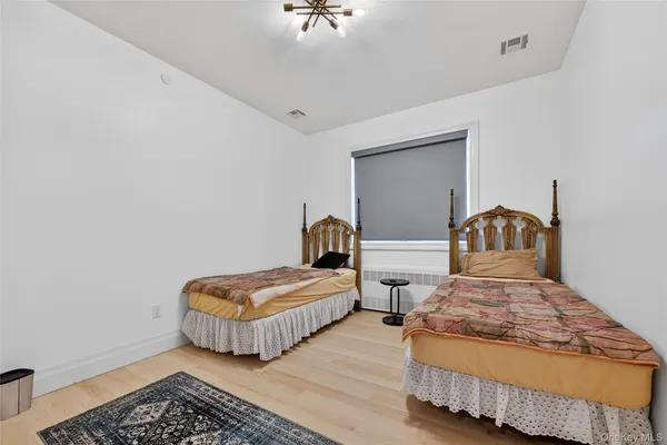 a bedroom with two beds and a rug