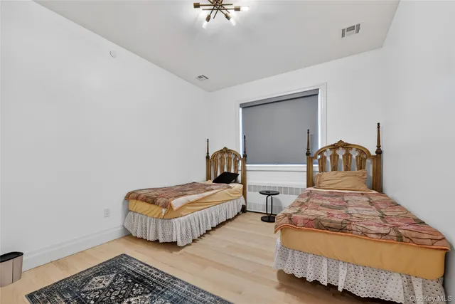 a bedroom with two beds and a rug