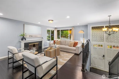 a living room with furniture a fireplace and a table
