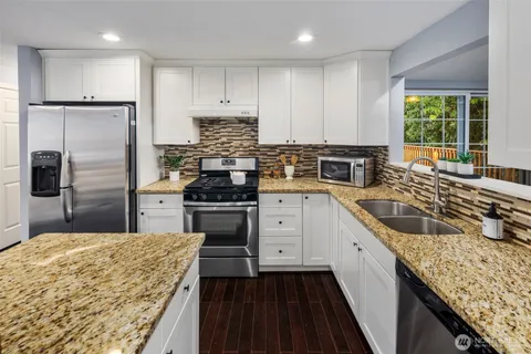 a kitchen with a sink stove and refrigerator