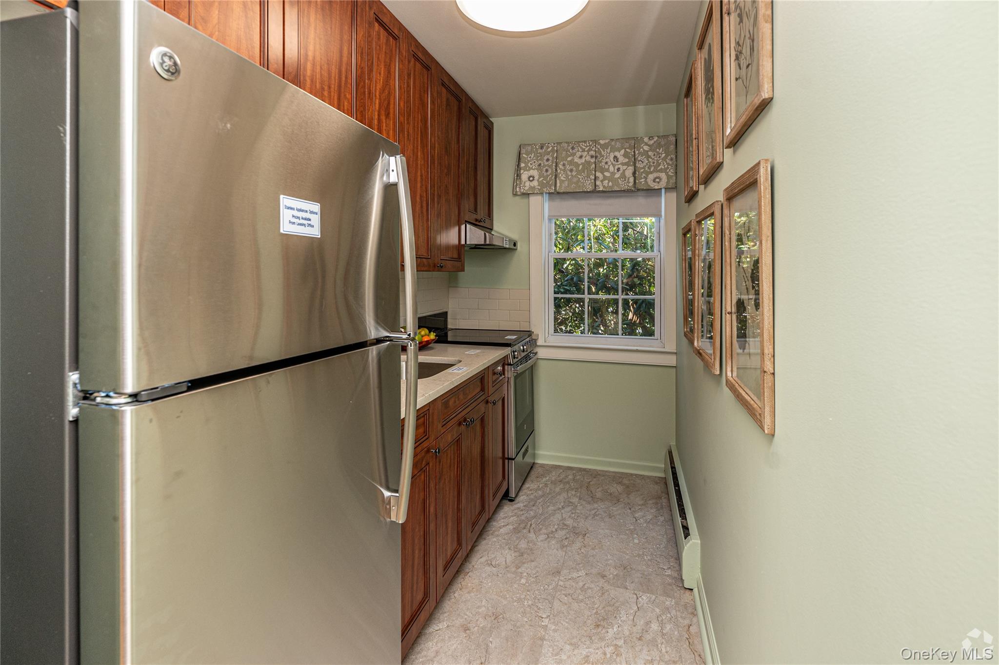 204 Milligan Road West Babylon, NY 11704 - Photo 7 of 12 a kitchen with a refrigerator and a stove