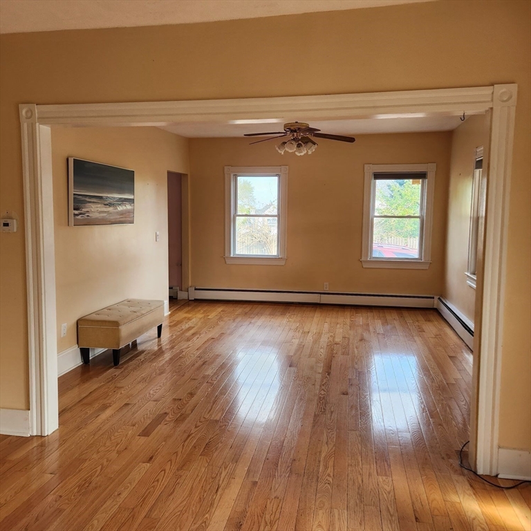 39 Squanto Road Weymouth, MA 02191 - Photo 5 of 13 a view of a hallway with wooden floor and windows