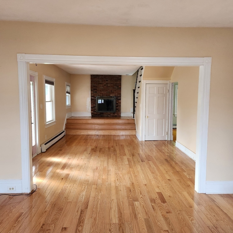 39 Squanto Road Weymouth, MA 02191 - Photo 6 of 13 a view of an empty room with wooden floor and a window
