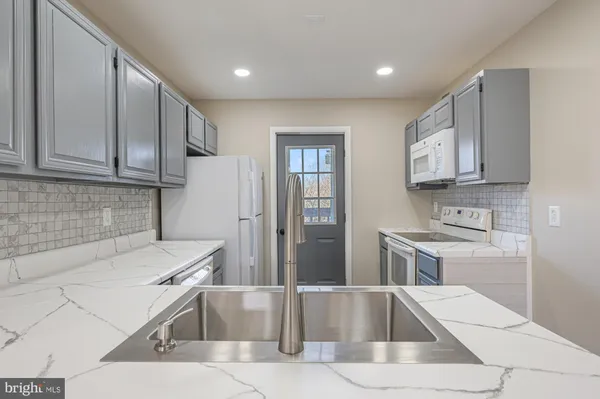 a kitchen with a sink cabinets and stainless steel appliances