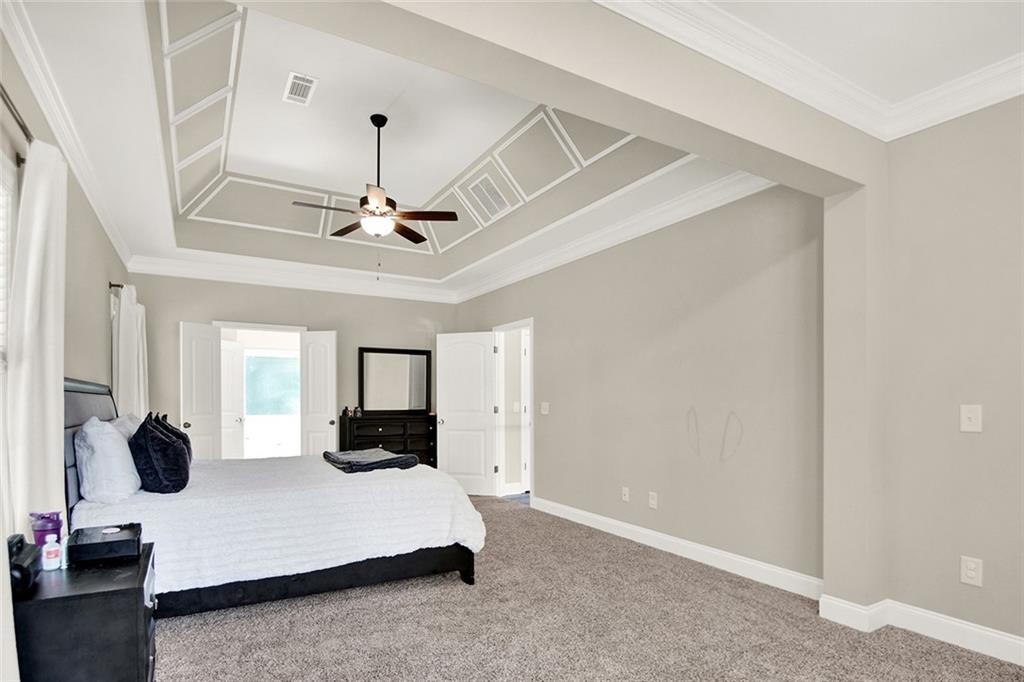 407 Corinth Church Road Winder, GA 30680 - Photo 39 of 66 a living room with furniture and a chandelier