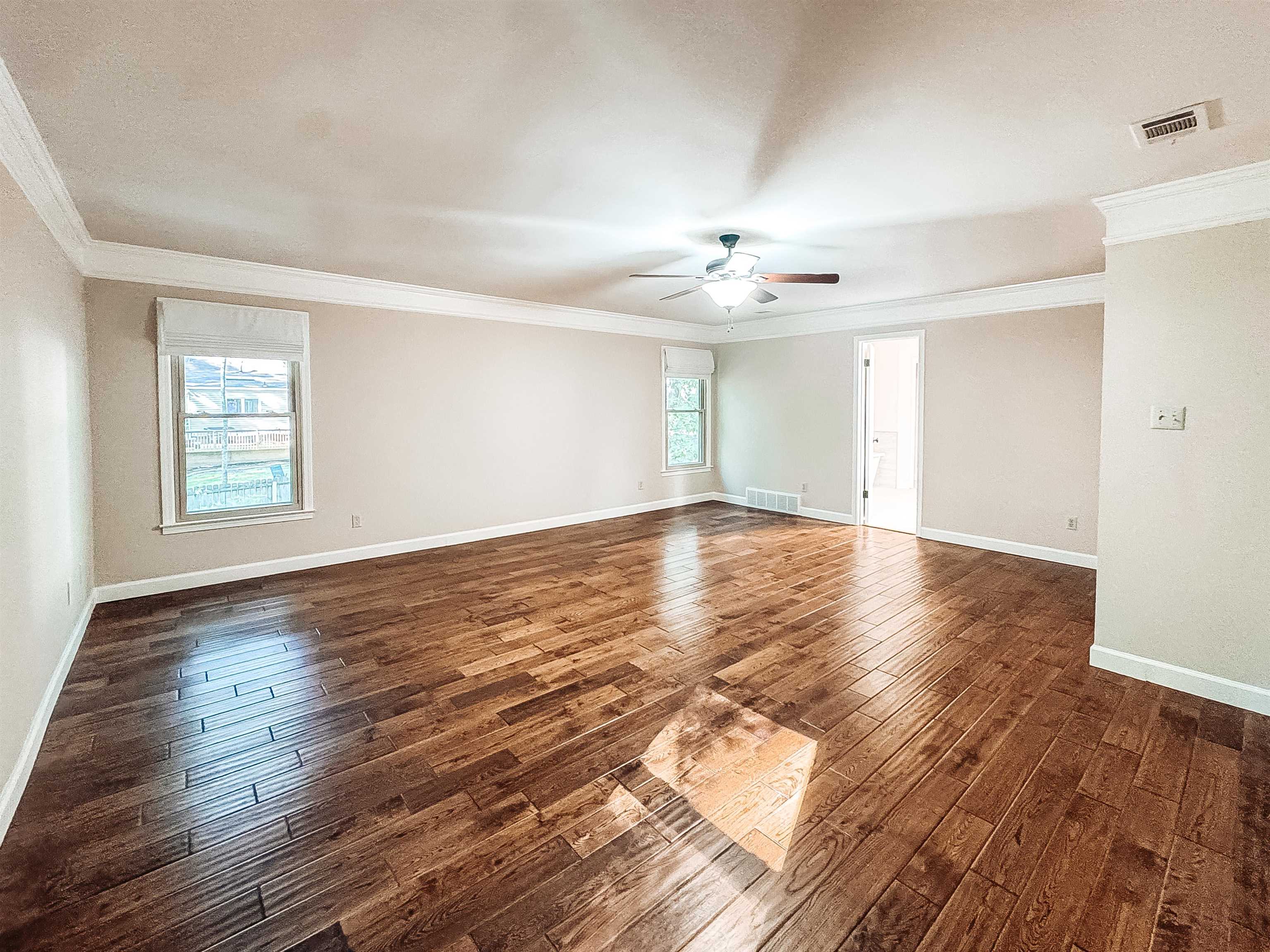 832 South Tree Drive Collierville, TN 38017 - Photo 28 of 40 Spacious room featuring wood-finish flooring, white crown molding, a ceiling fan, and two windows with Roman shades