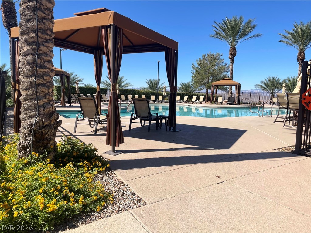 2805 Proust Court Henderson, NV 89044 - Photo 2 of 43 An inviting community pool with private cabanas and palm trees awaits your enjoyment.