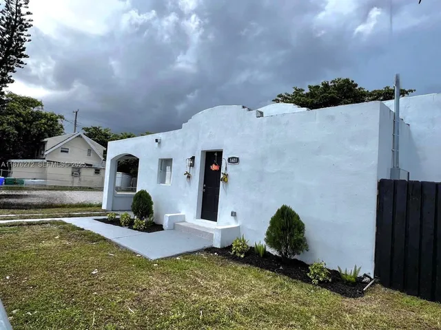 an aerial view of a house with a yard and potted plants