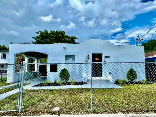 a view of backyard with wooden fence