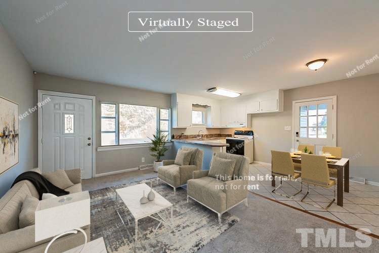 6108 Cheek Road Durham, NC 27704 - Photo 2 of 14 a living room with furniture and a large window