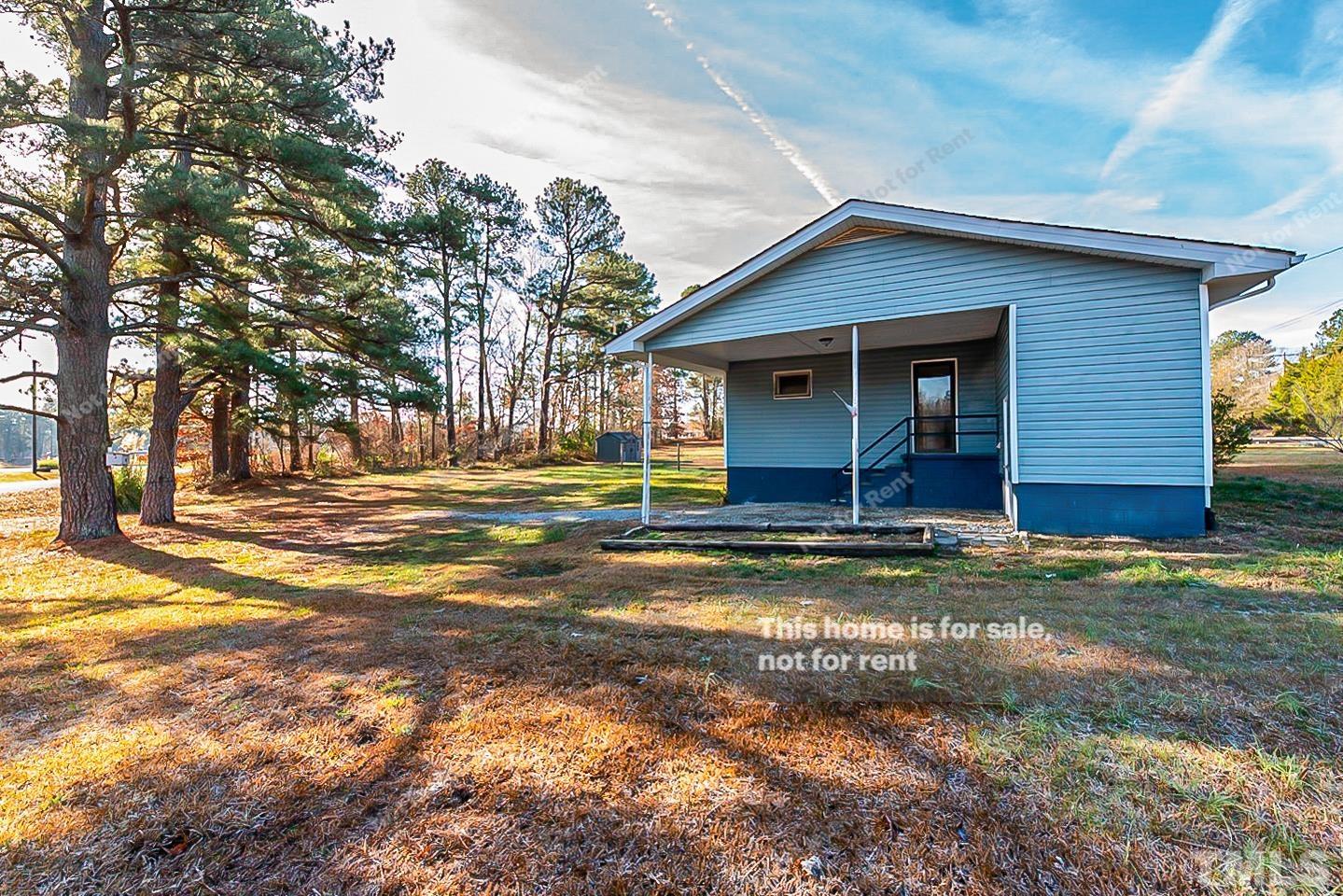 6108 Cheek Road Durham, NC 27704 - Photo 13 of 14 a view of a house with a yard and large tree