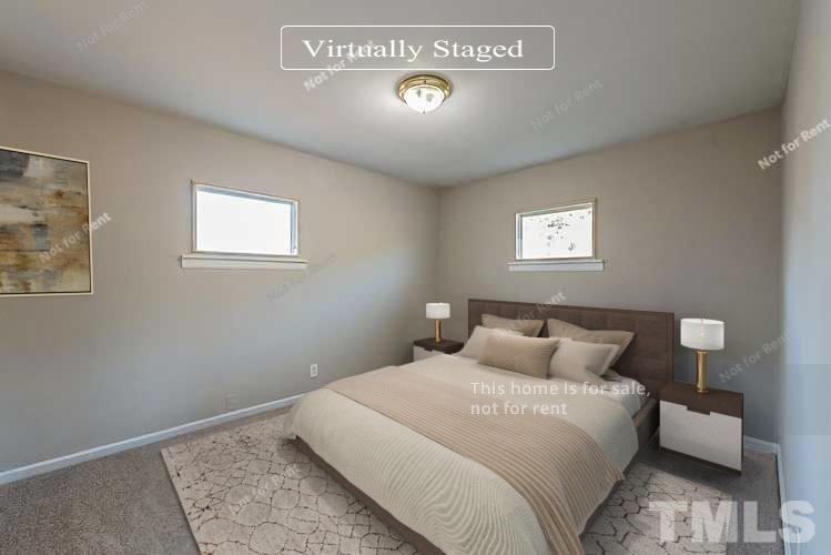 6108 Cheek Road Durham, NC 27704 - Photo 3 of 14 a bedroom with a bed and a window