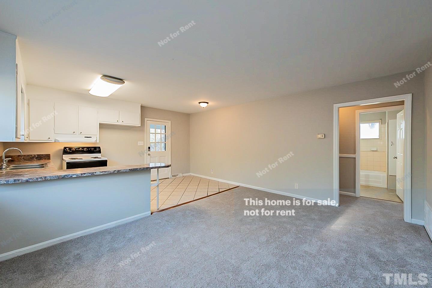 6108 Cheek Road Durham, NC 27704 - Photo 5 of 14 a view of a kitchen with a sink and cabinets