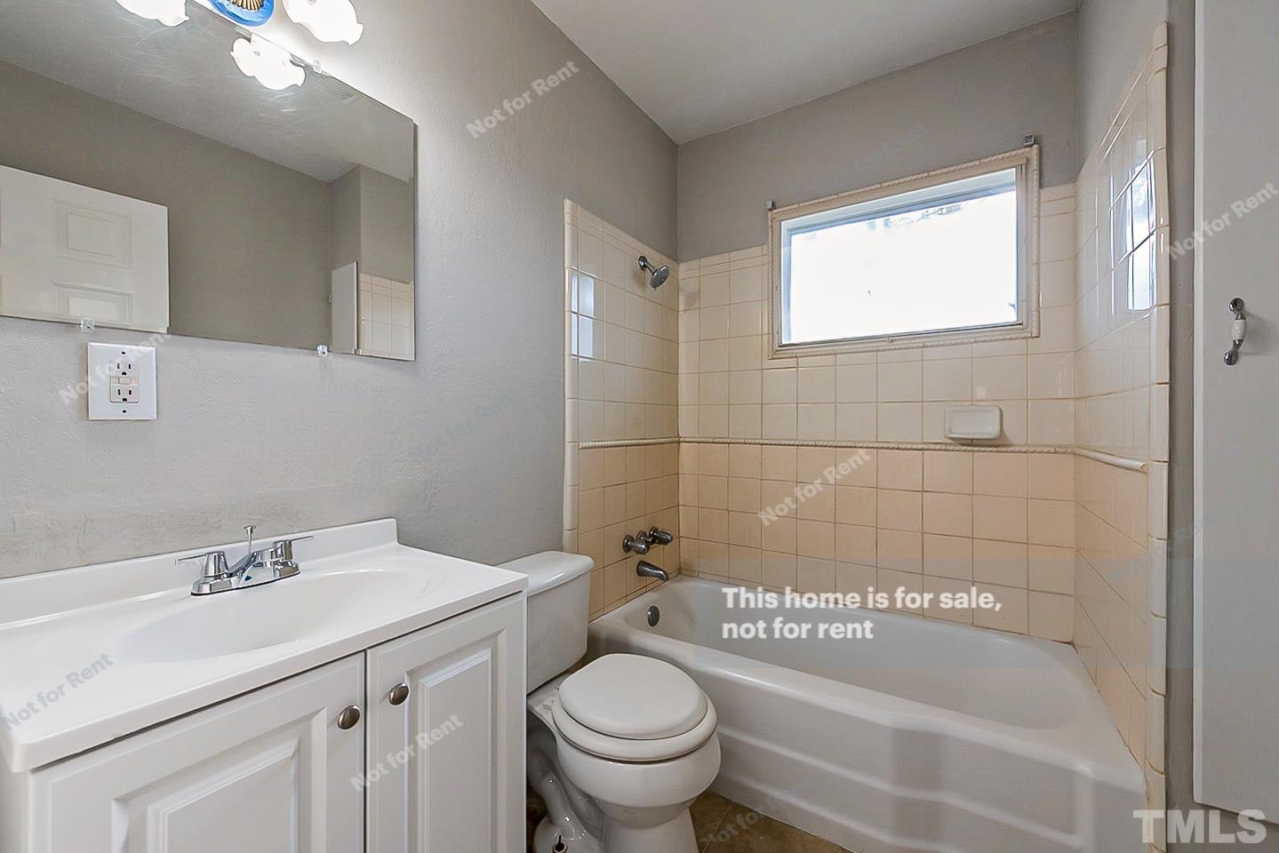 6108 Cheek Road Durham, NC 27704 - Photo 6 of 14 a bathroom with a sink a toilet and shower