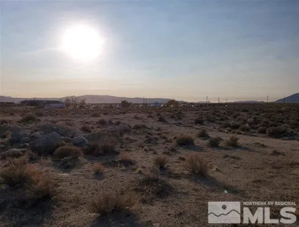 an aerial view of house with yard and mountain view in back