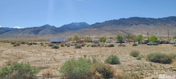 a view of a town with mountains in the background