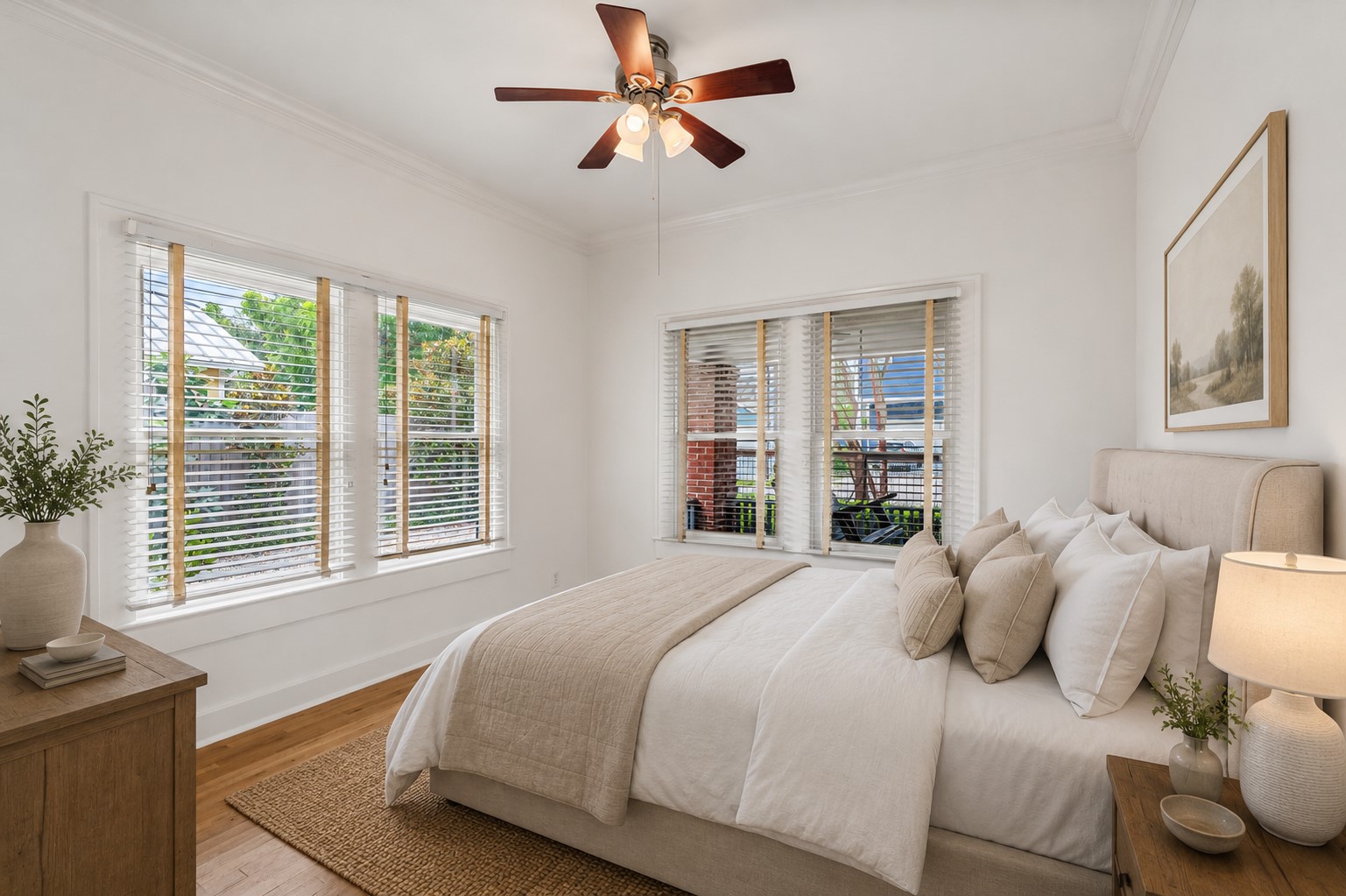 307 East 8th Street Houston, TX 77007 - Photo 20 of 35 Secondary bedroom #1 featuring hardwood floors, crown molding, a ceiling fan with light fixture, and two walls of large windows with blinds that fill the room with natural light. A wall closet provides convenient storage. **Note this photo has been virtually staged.