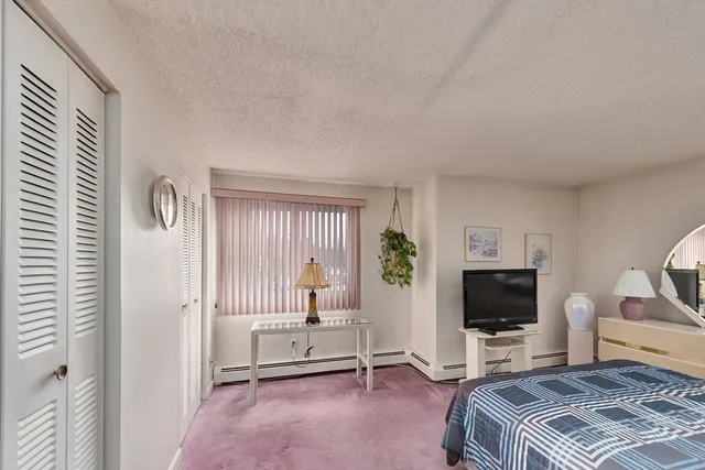 a bedroom with furniture and a flat screen tv