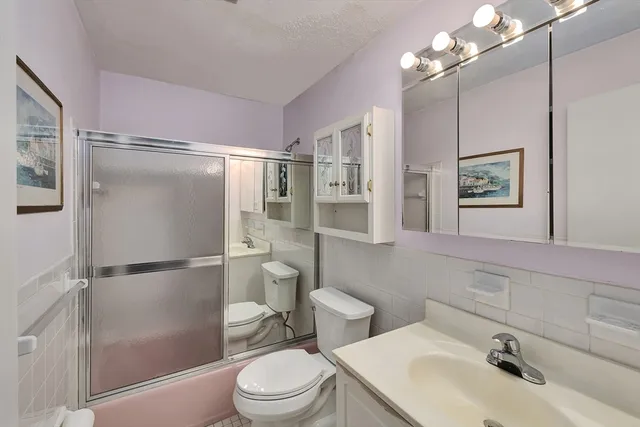 a white toilet sitting next to a bathroom sink