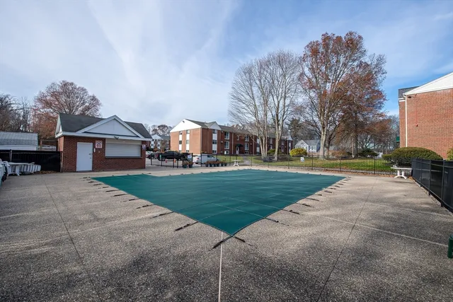 a view of a house with a big yard and large trees