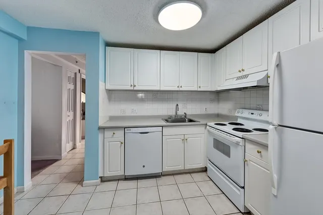 a kitchen with cabinets appliances and a sink