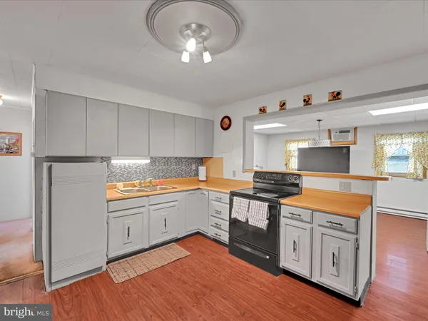 a kitchen with granite countertop white cabinets and stainless steel appliances