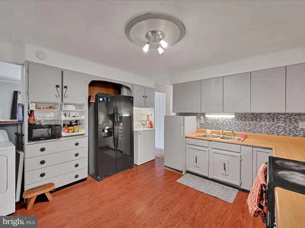 a kitchen with stainless steel appliances granite countertop a stove and a wooden floors