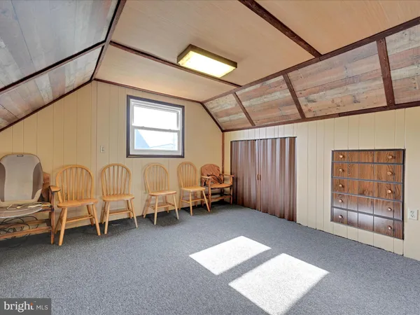 a view of a livingroom with furniture and a window