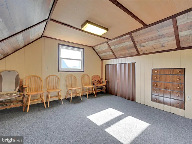a view of a livingroom with furniture and a window