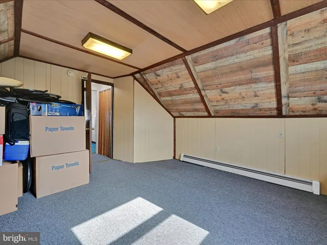 a view of an empty room with a fireplace and a window