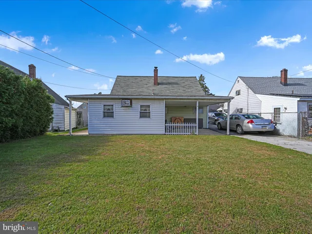 a view of a house with a backyard porch and sitting area