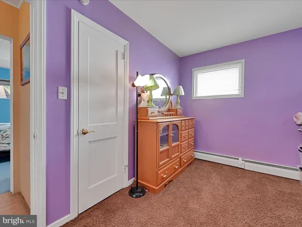 a view of a livingroom with an empty space and a hallway