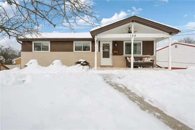 a front view of a house with sitting space