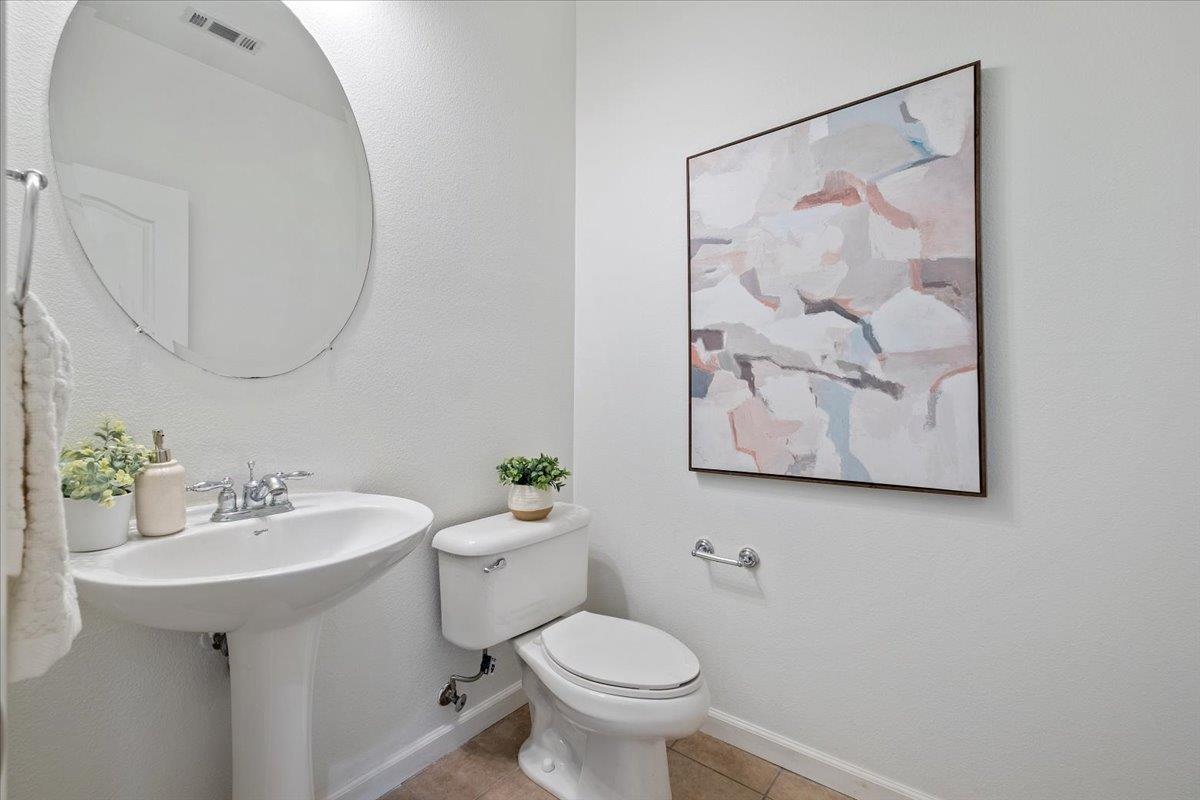 2413 Ventana View Way Modesto, CA 95355 - Photo 22 of 51 a bathroom with a toilet sink and mirror