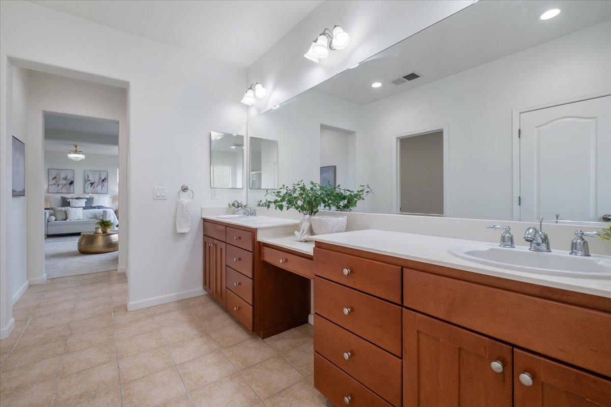 2413 Ventana View Way Modesto, CA 95355 - Photo 30 of 51 a spacious bathroom with a granite countertop double vanity sink a mirror and shower