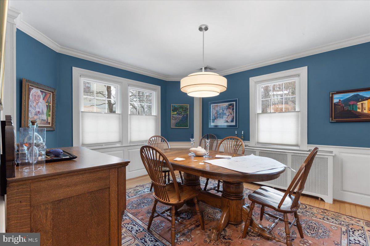 130 Hilltop Road Silver Spring, MD 20910 - Photo 12 of 48 a dining room with furniture a chandelier and window