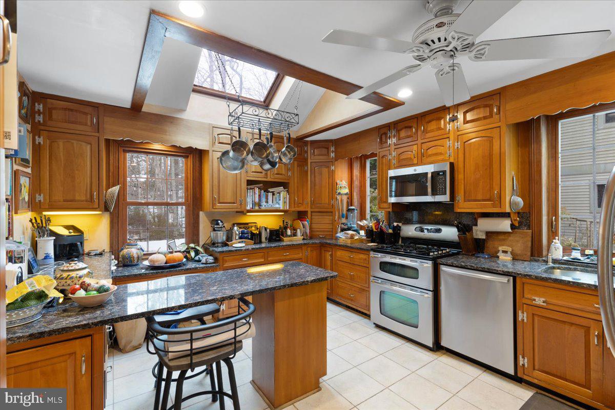 130 Hilltop Road Silver Spring, MD 20910 - Photo 13 of 48 a kitchen with stainless steel appliances a sink stove and refrigerator
