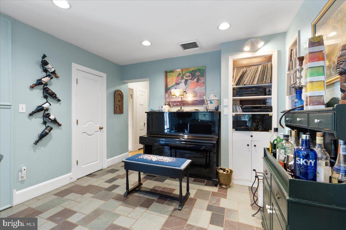 130 Hilltop Road Silver Spring, MD 20910 - Photo 21 of 48 a living room with furniture a flat screen tv and a fireplace