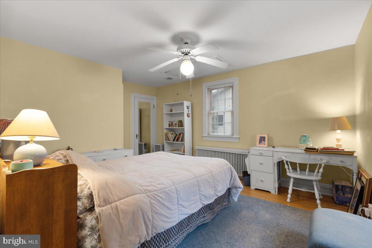 130 Hilltop Road Silver Spring, MD 20910 - Photo 37 of 48 a bedroom with a bed and a chandelier