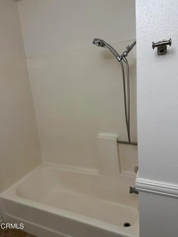 a bathroom with a granite countertop toilet sink and mirror