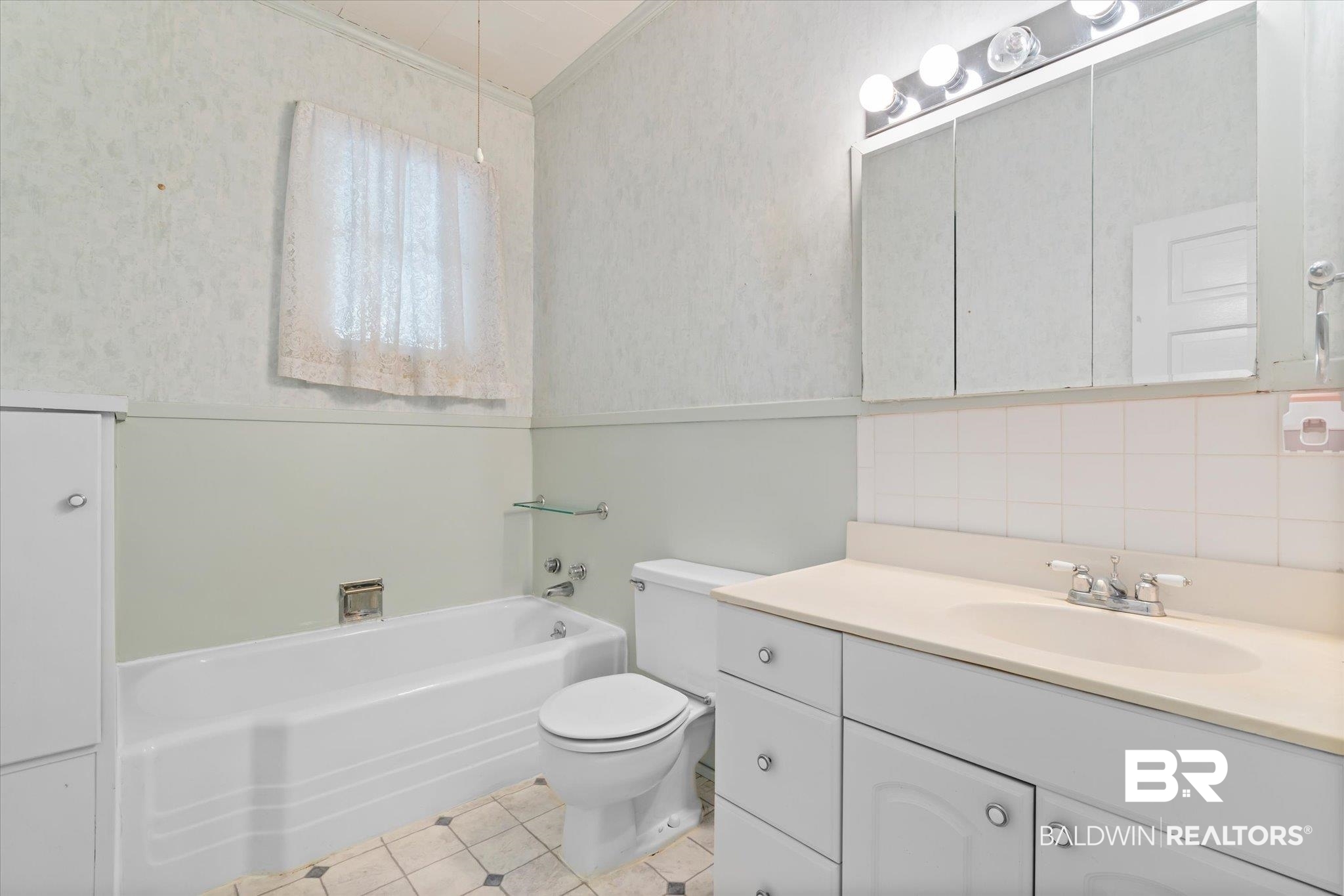 211 3rd Street Mobile, AL 36611 - Photo 11 of 20 Bathroom with tasteful backsplash, vanity, crown molding, a tub, and toilet