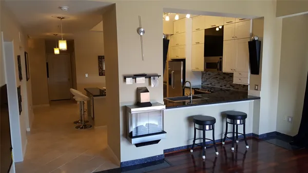 a very nice looking room with a large window and wooden floor