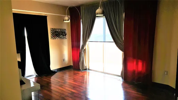 an entryway with a window and wooden floor