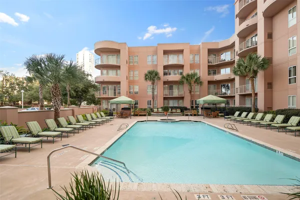 a view of a swimming pool with outdoor seating