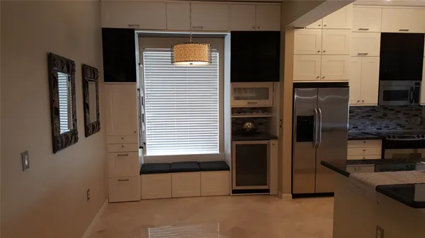 a kitchen with stainless steel appliances kitchen island granite countertop a refrigerator and a stove top oven