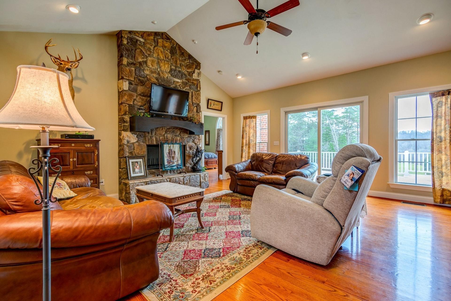 565 Charlie Road Hardy, VA 24101 - Photo 20 of 58 a living room with furniture a fireplace and a flat screen tv