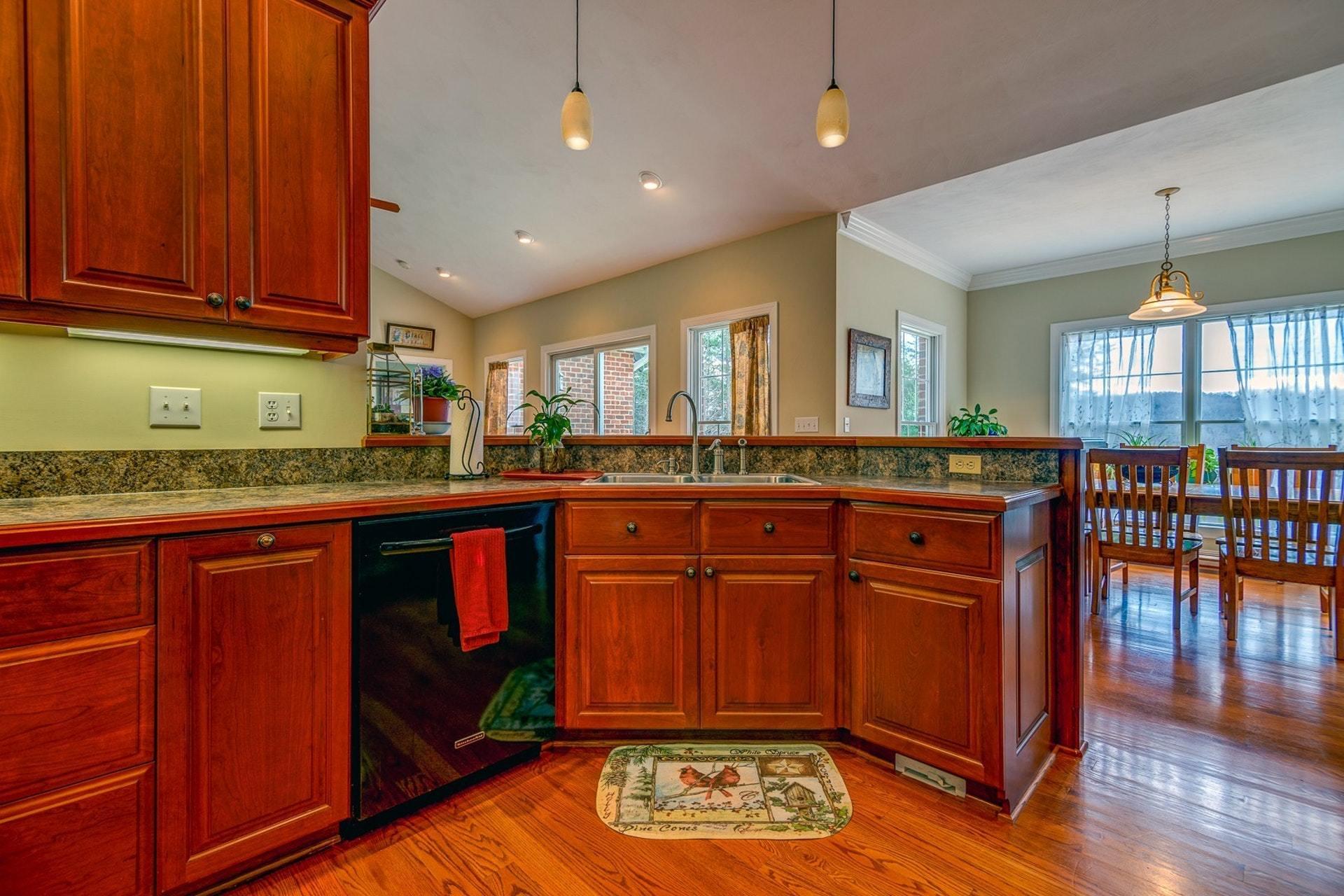 565 Charlie Road Hardy, VA 24101 - Photo 21 of 58 a kitchen with granite countertop a stove a sink dishwasher and cabinets with wooden floor