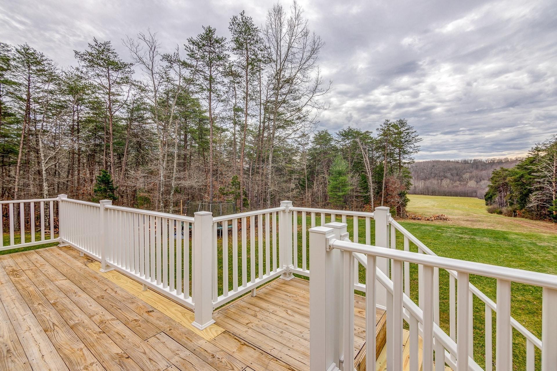 565 Charlie Road Hardy, VA 24101 - Photo 34 of 58 a view of a wooden deck and trees with wooden fence