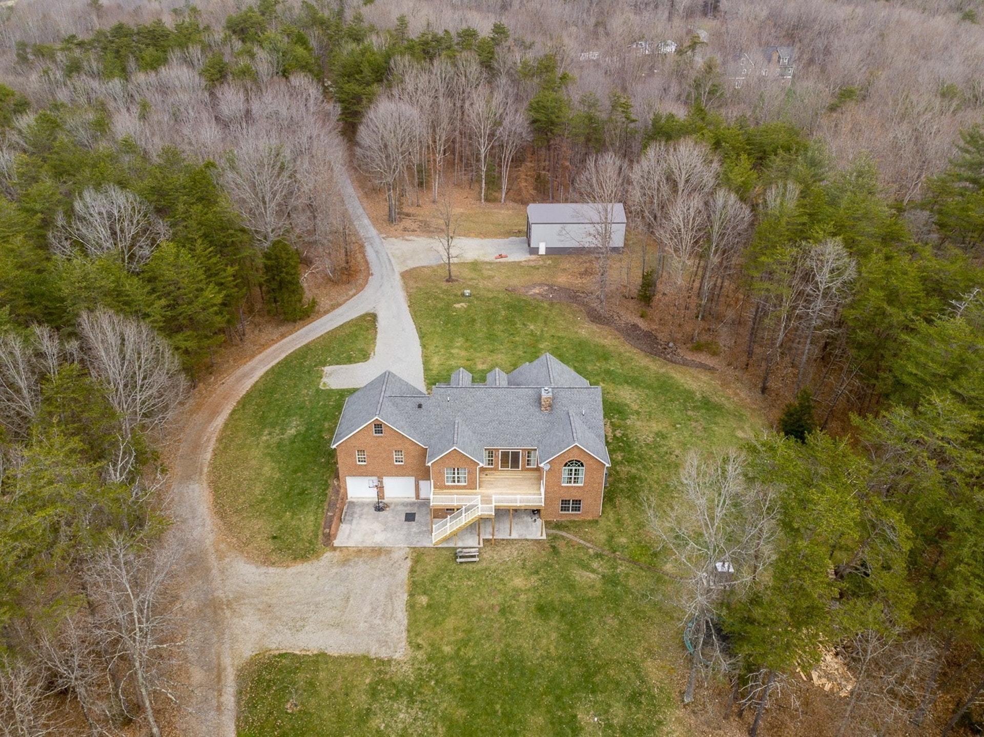 565 Charlie Road Hardy, VA 24101 - Photo 48 of 58 an aerial view of a house with swimming pool and large trees